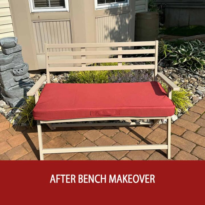 A bench painted with a red cushion in front of a baywindow - after bench makeover at the bottom in red