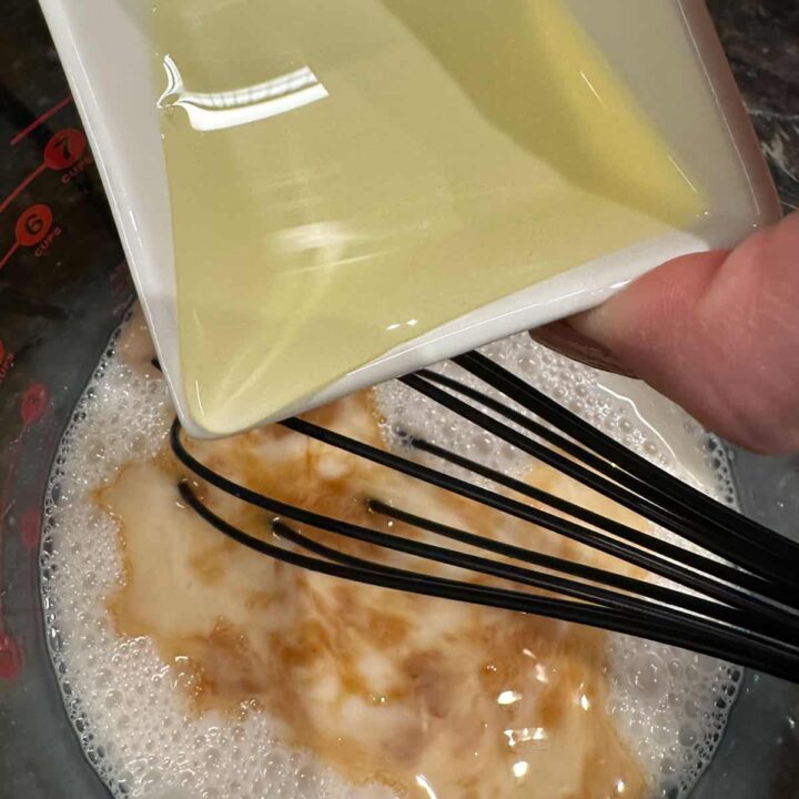 adding oil to the rest of the liquid in the bowl.