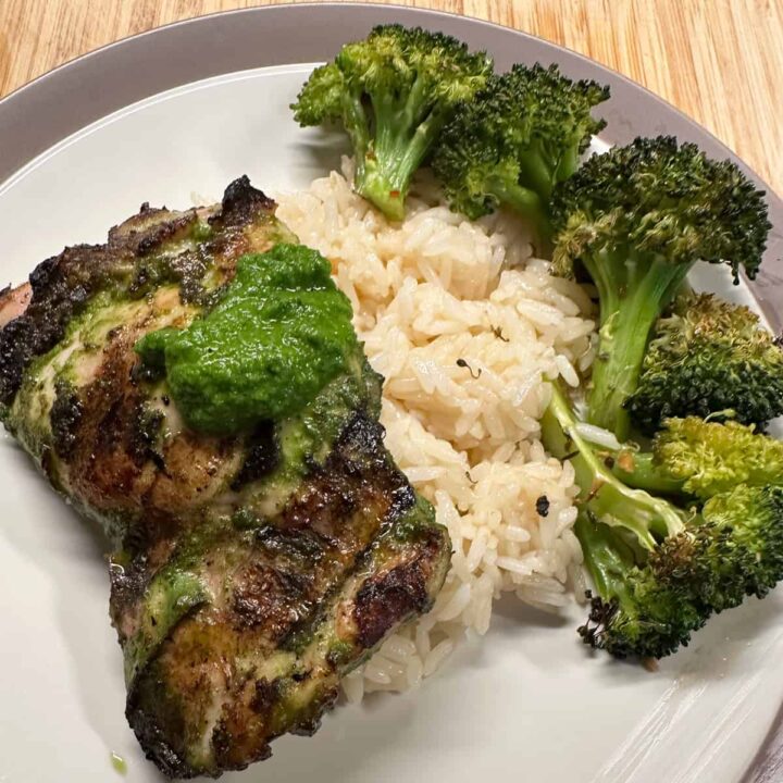 chicken thigh rice and broccoli on a plate no title