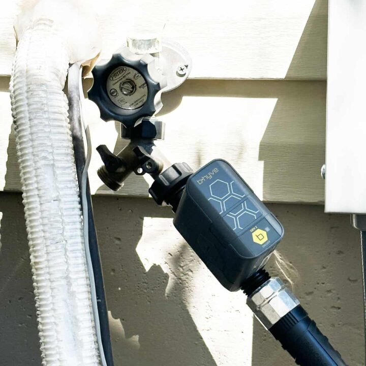 A faucet outdoors with the orbit attached to a diverter