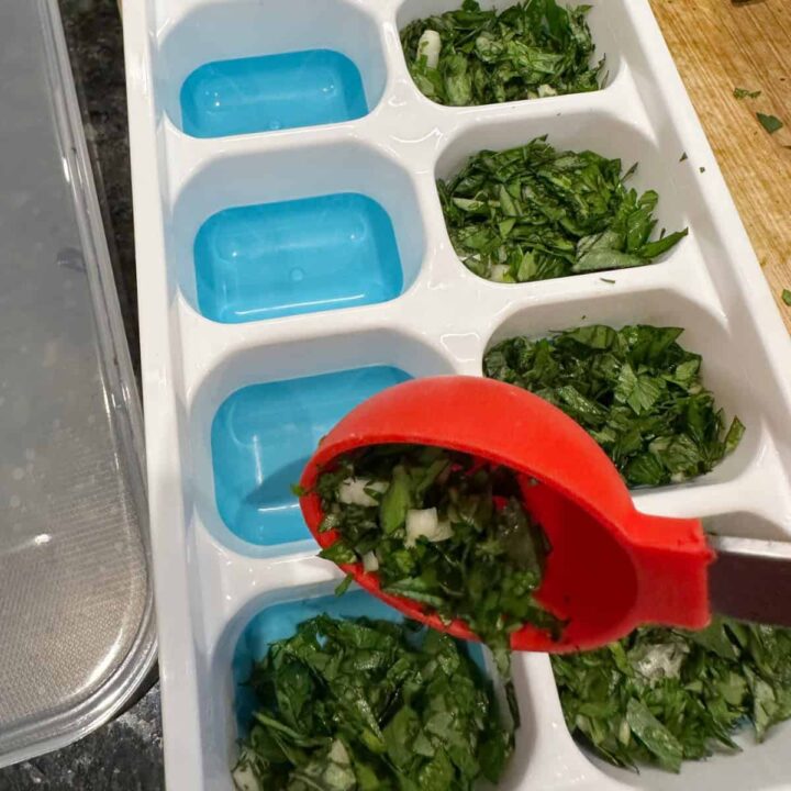 Add Parsley Basil Garlic Mix to Tray - spoon into the departments - square image