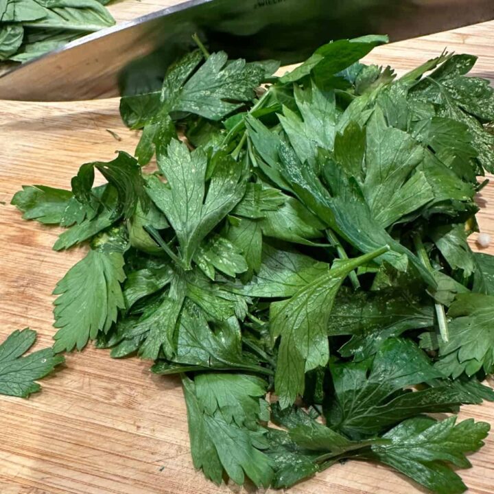 Chopped parsley on a cutting board - square image
