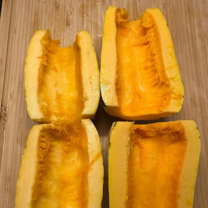 cleaned and cut delicata squash open on a cutting board. - square image