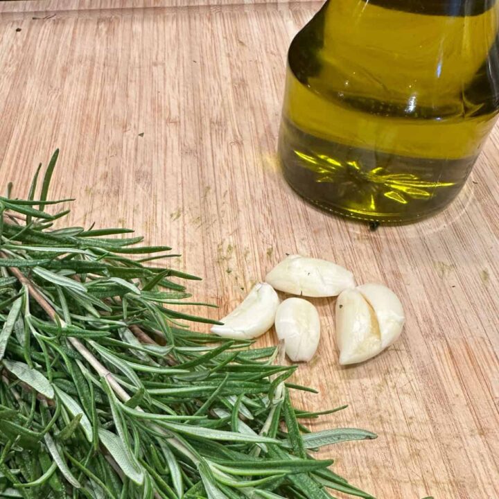 garlic rosemary olive oil on cutting board -square image