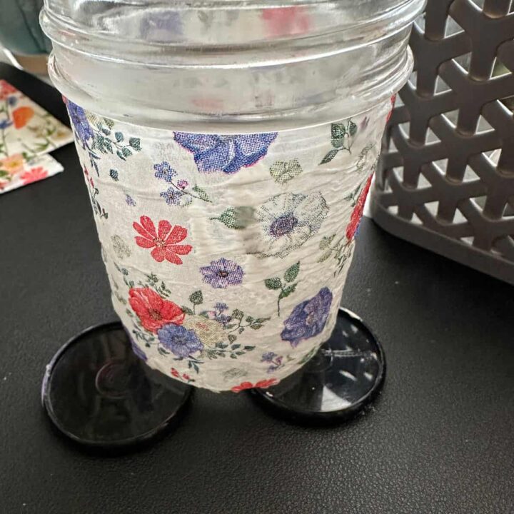 mason jar covered with decorative napkin on rings to raise it up.