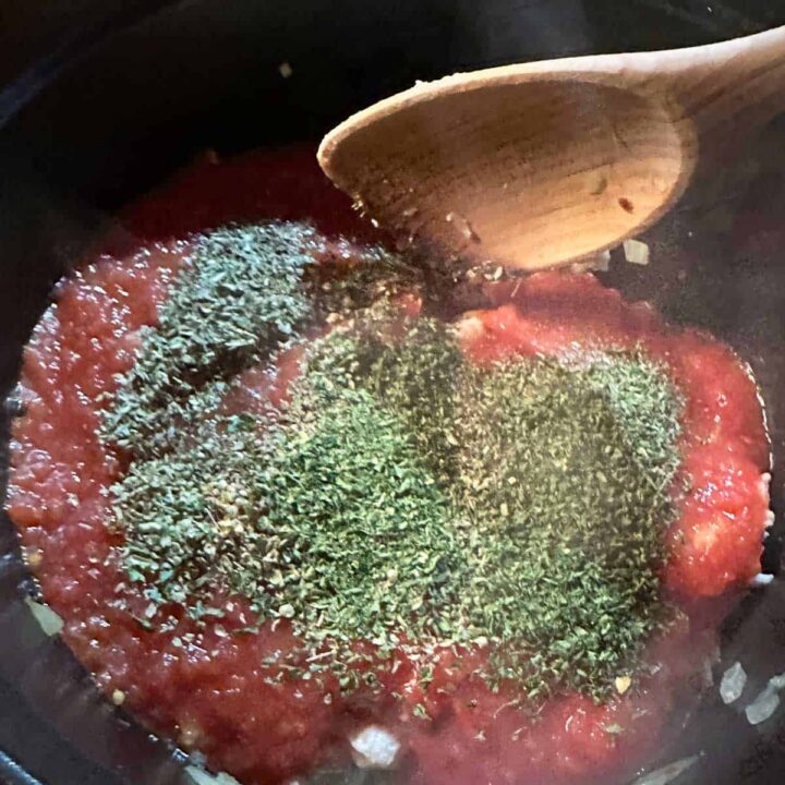 Add tomatoes and herbs to sauce pan - square image