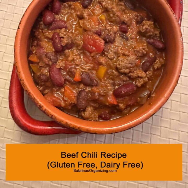 Title at the bottom - beef chili in a bowl with handles. square image