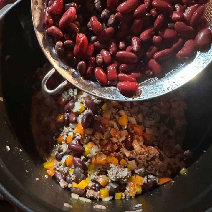 Bean in a strainer going in the pot - square image