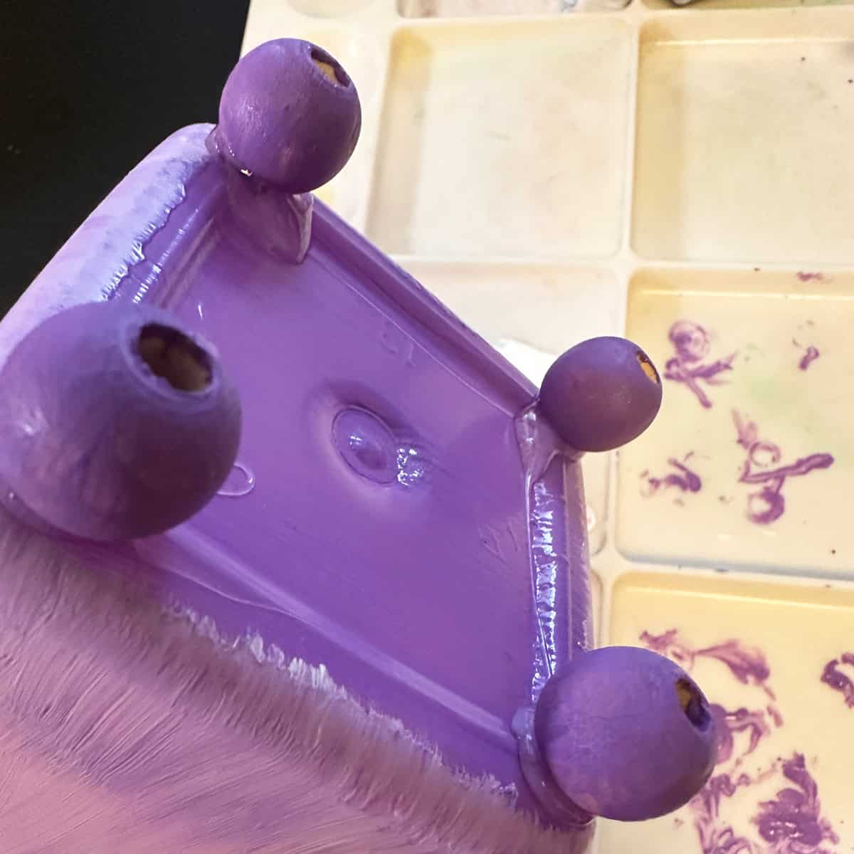 Add painted wooden feet to bottom of bottle