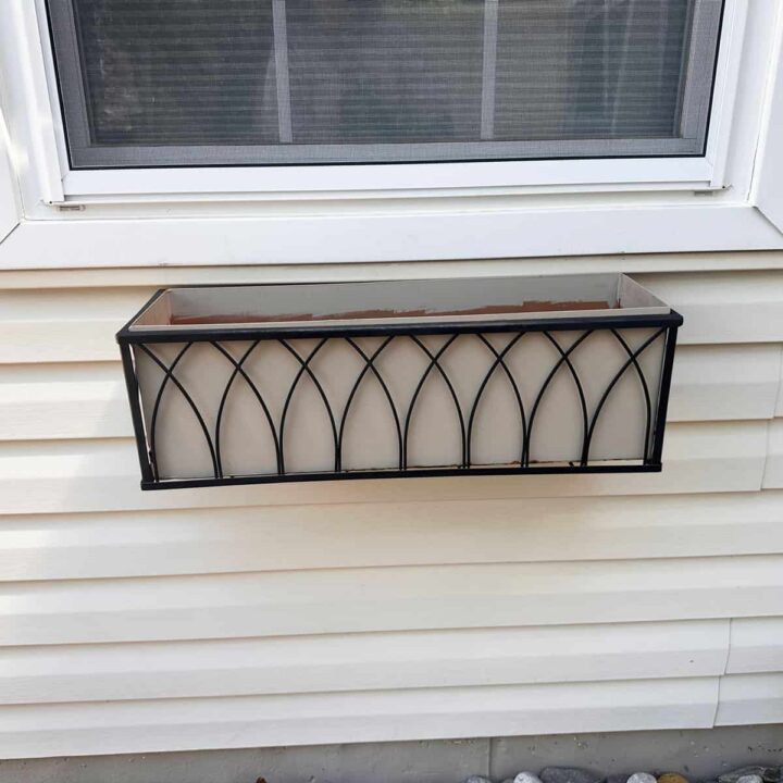 A window box mounted to below the garage window. square image