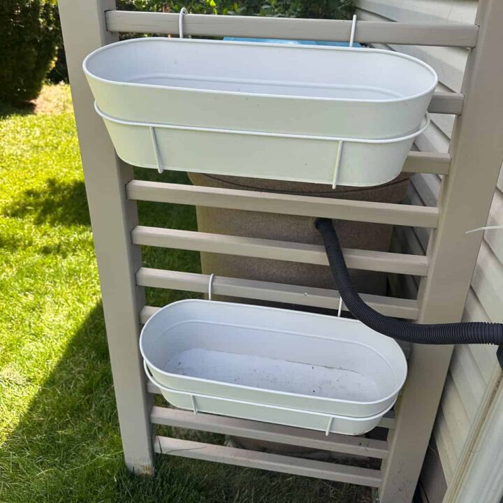 window box mounted to a freestanding frame that hides the trash cans and rainbarral. square image
