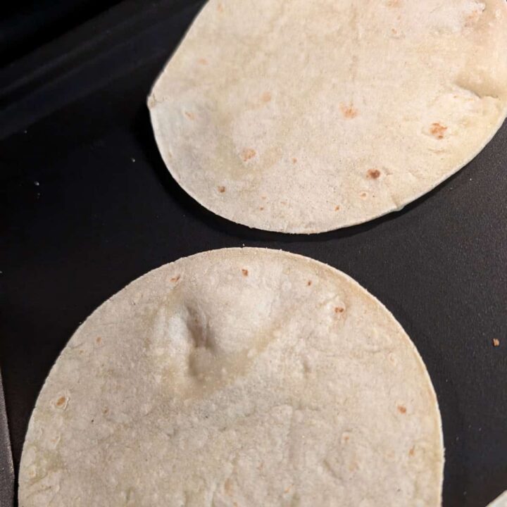 tortilla on a griddle heating up - square image