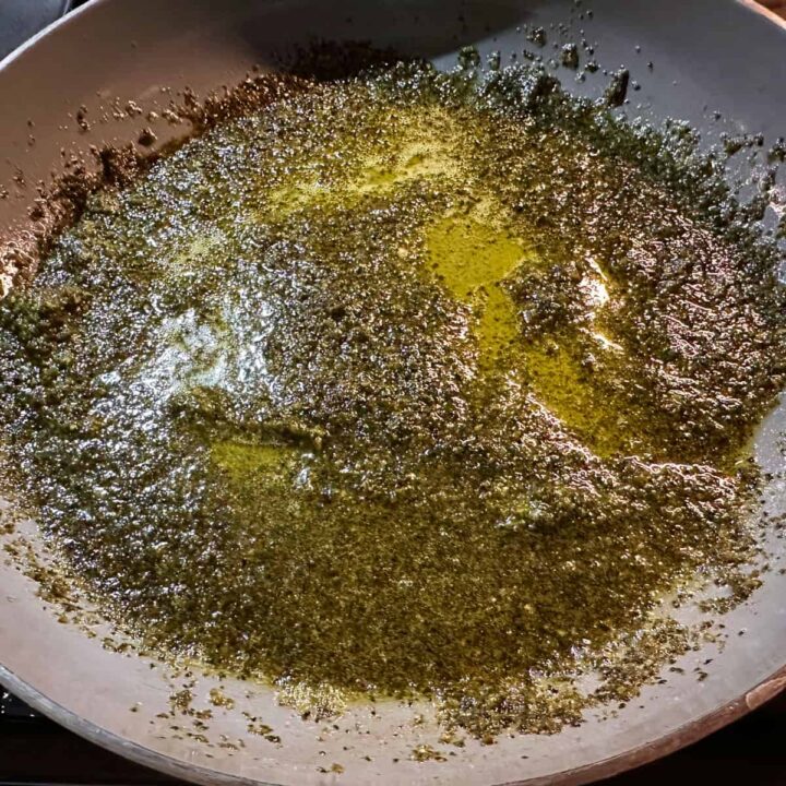 Melted basil pesto bombs in skillet