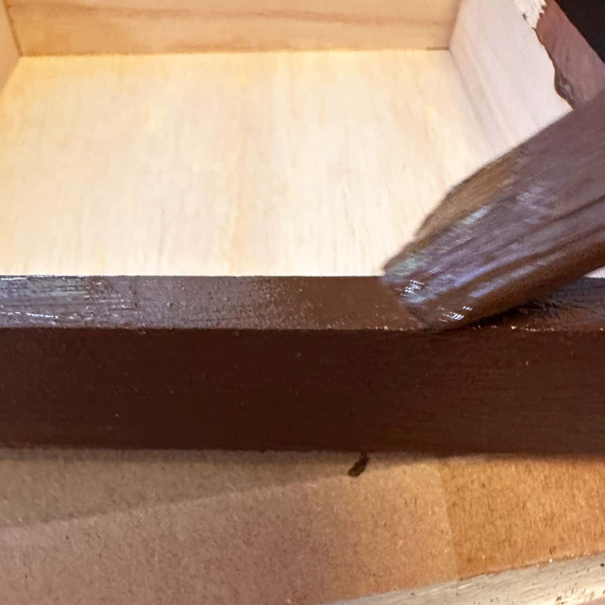 paint brown with paint brush on the box - square image