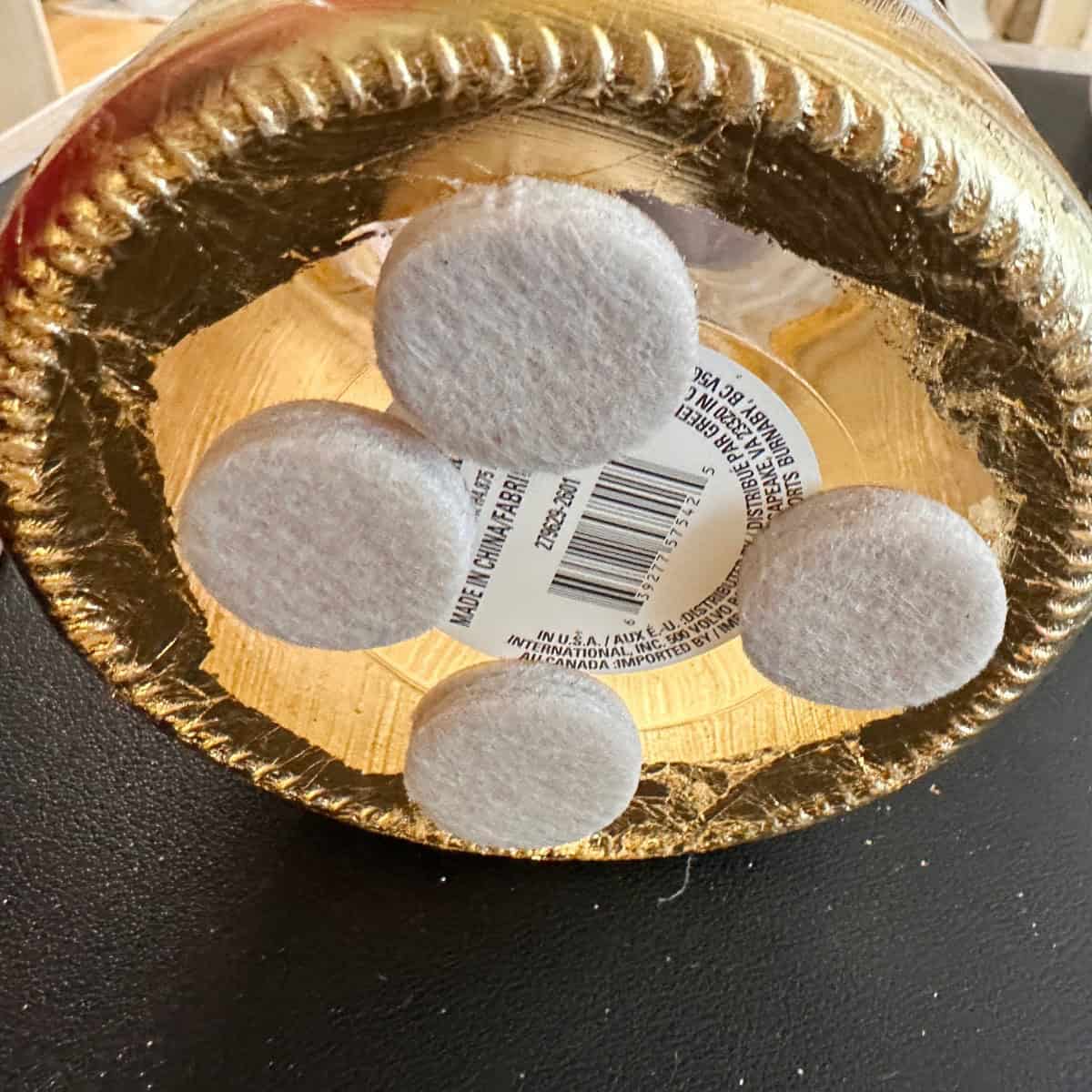 Add felt pads to bottom of vase