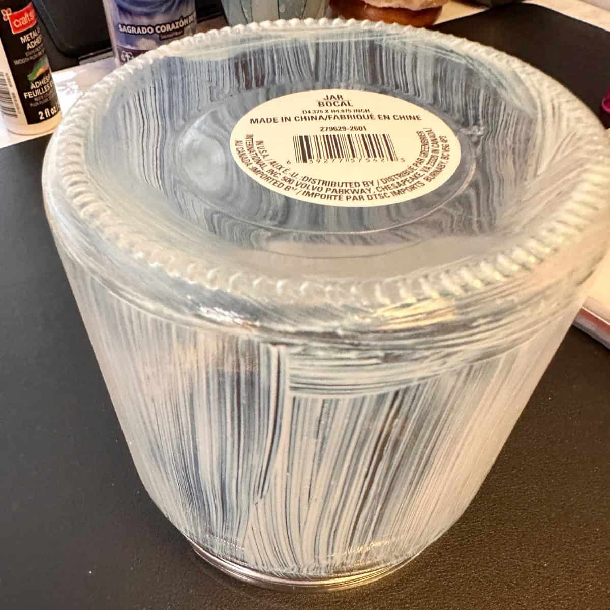 Add glue to glass vase
