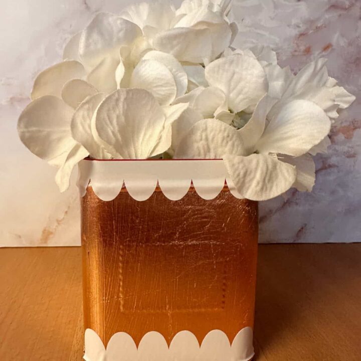 After tin box with faux flowers no label
