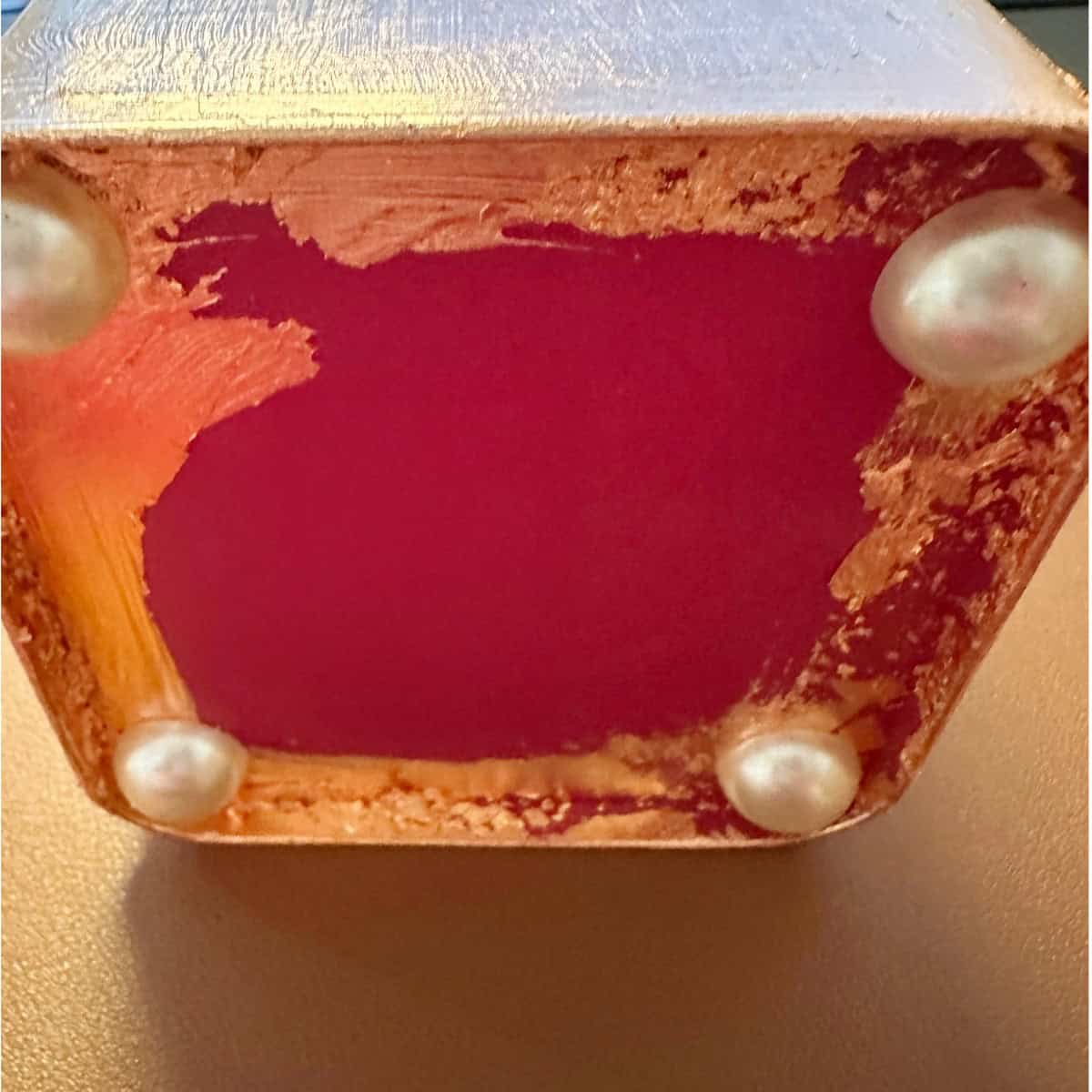 Add large pearl stickers for feet under tin